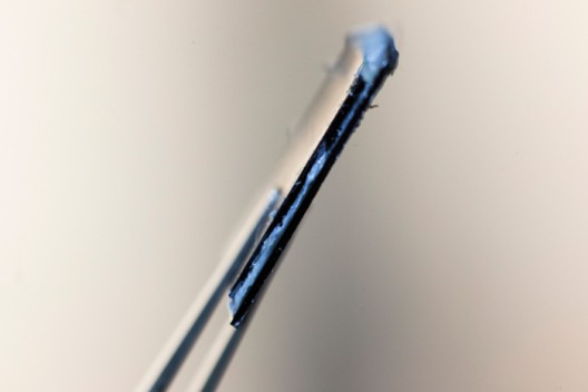 Vanderbilt's structural supercapacitor prototype, oozing polymer like cheese from a panini