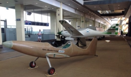 Bat on display at trade show drew large crowds, including school children who took "rides" in F1 racer