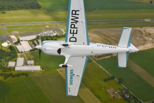A high power-to-weight ratio is welcome in aerobatics. Note lack of exhaust pipes, oil stains on bellow of Extra 330 LE